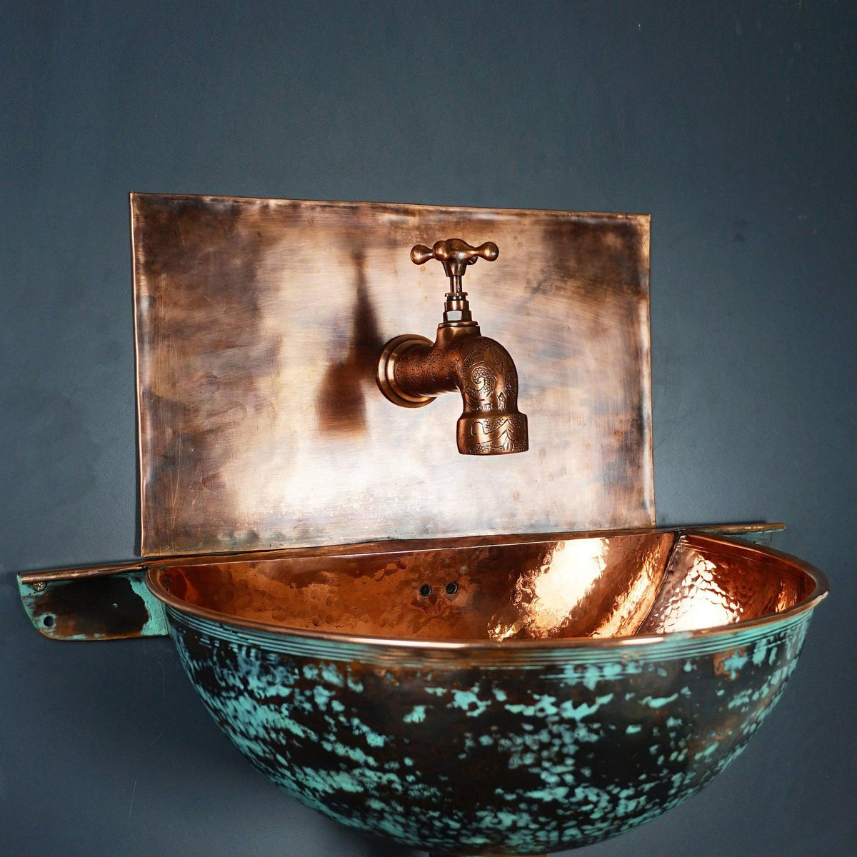 Green patina copper wall-mounted sink for a compact powder room
