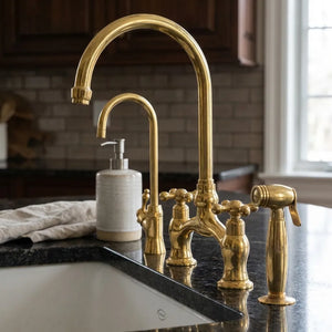 Gold kitchen faucet set on a countertop with a sink in a kitchen setting.