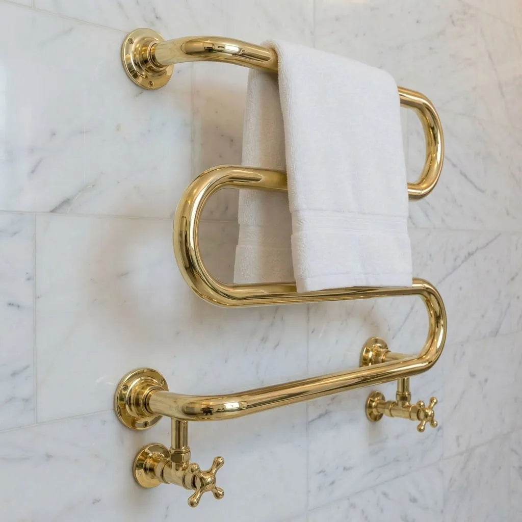 Handmade unlacquered brass hydronic towel warmer with serpentine rails and crosshead valves
