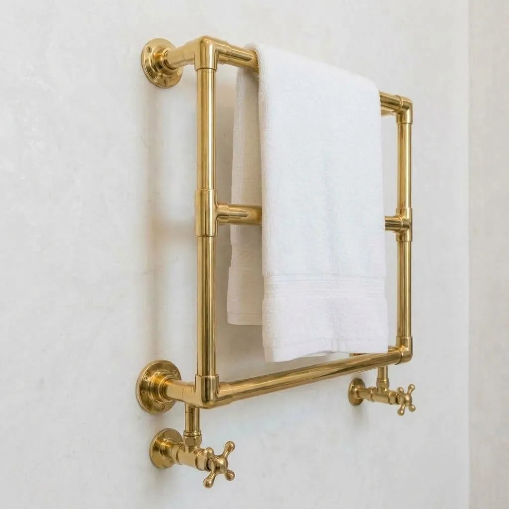 Wall-mounted unlacquered brass hydronic heated towel rail with three bars and traditional crosshead valves