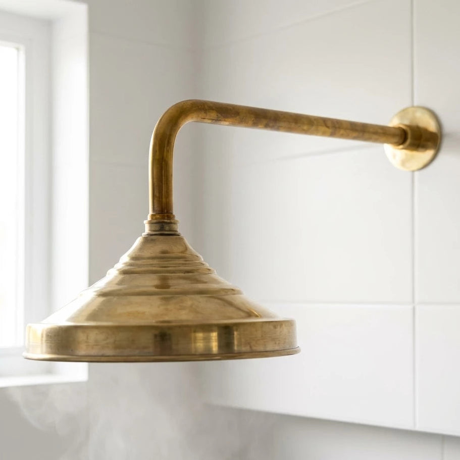 Brass wall-mounted light fixture on a white kitchen wall