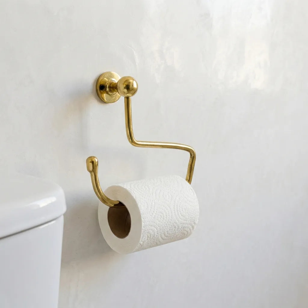 Curved brass toilet paper holder with natural patina finish
