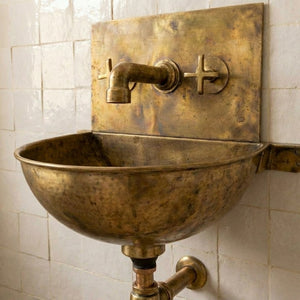 Vintage brass wall mounted sink with unlacquered brass faucet