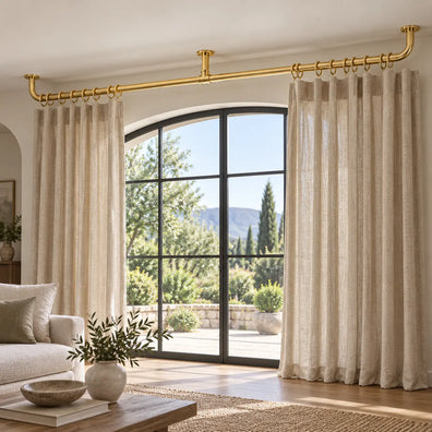 Extra-long two-piece brass curtain rod with central ceiling support over a wide window