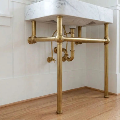 Handmade brass bathroom washstand frame with integrated front towel rail, angled view