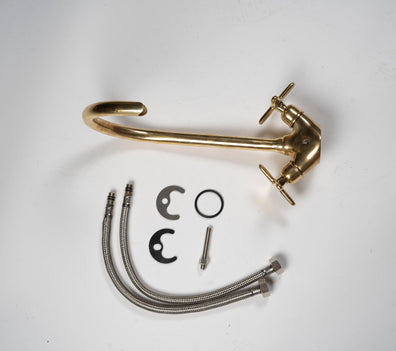 Unlacquered brass gooseneck bathroom faucet with flexible supply lines and installation parts
