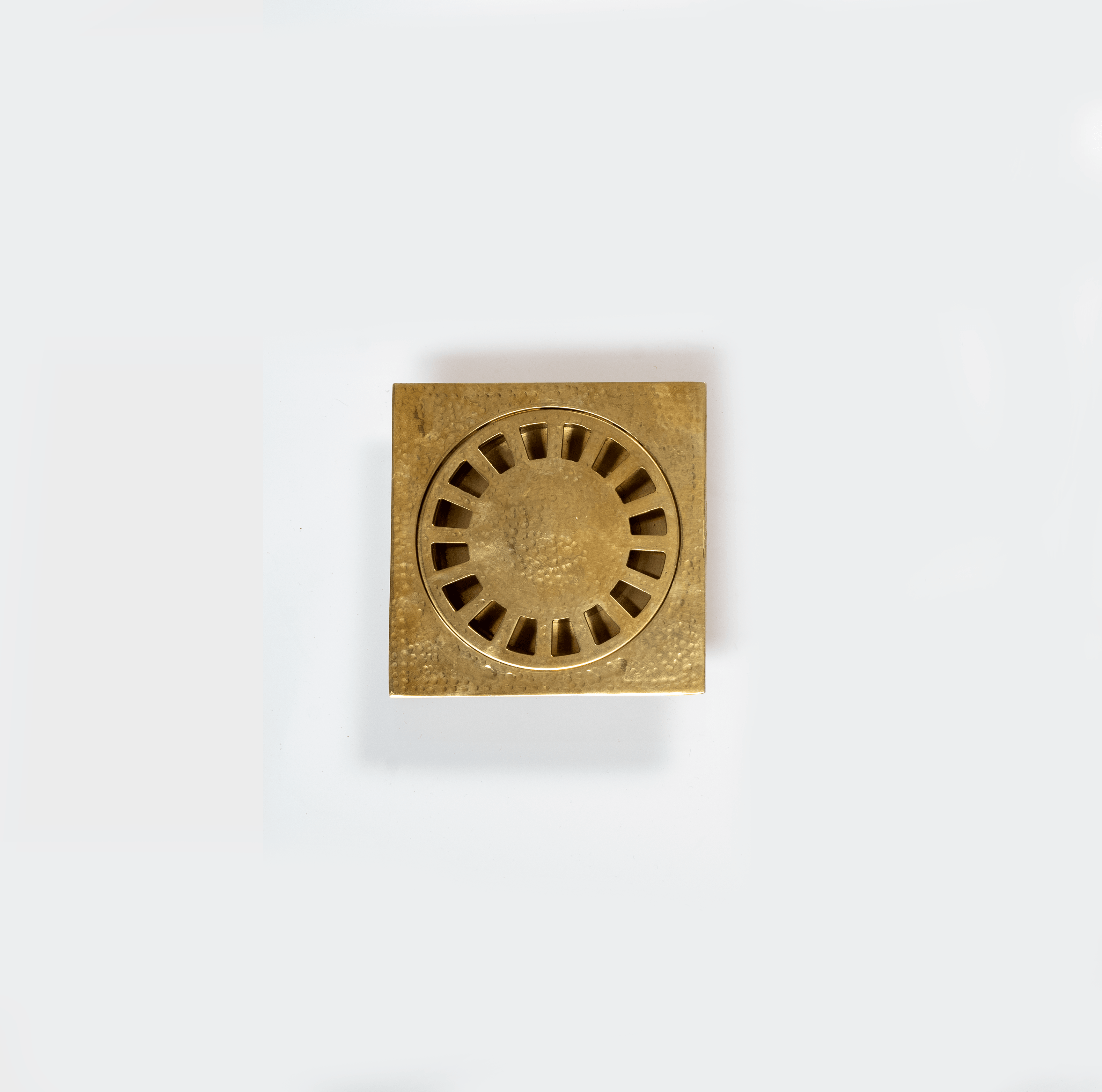 Hammered unlacquered brass square shower drain with removable round cover