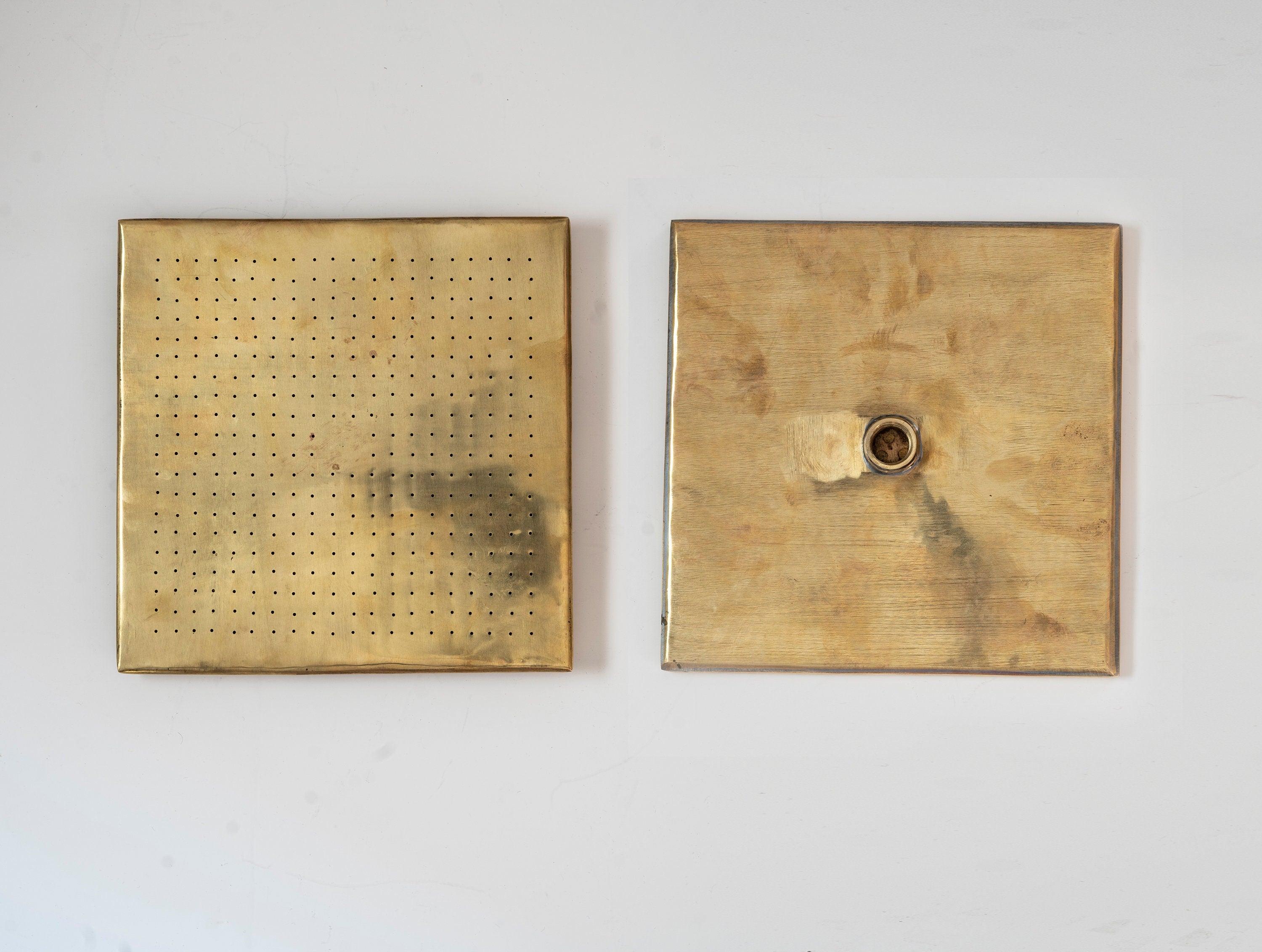Front and back views of a square unlacquered brass rain shower head
