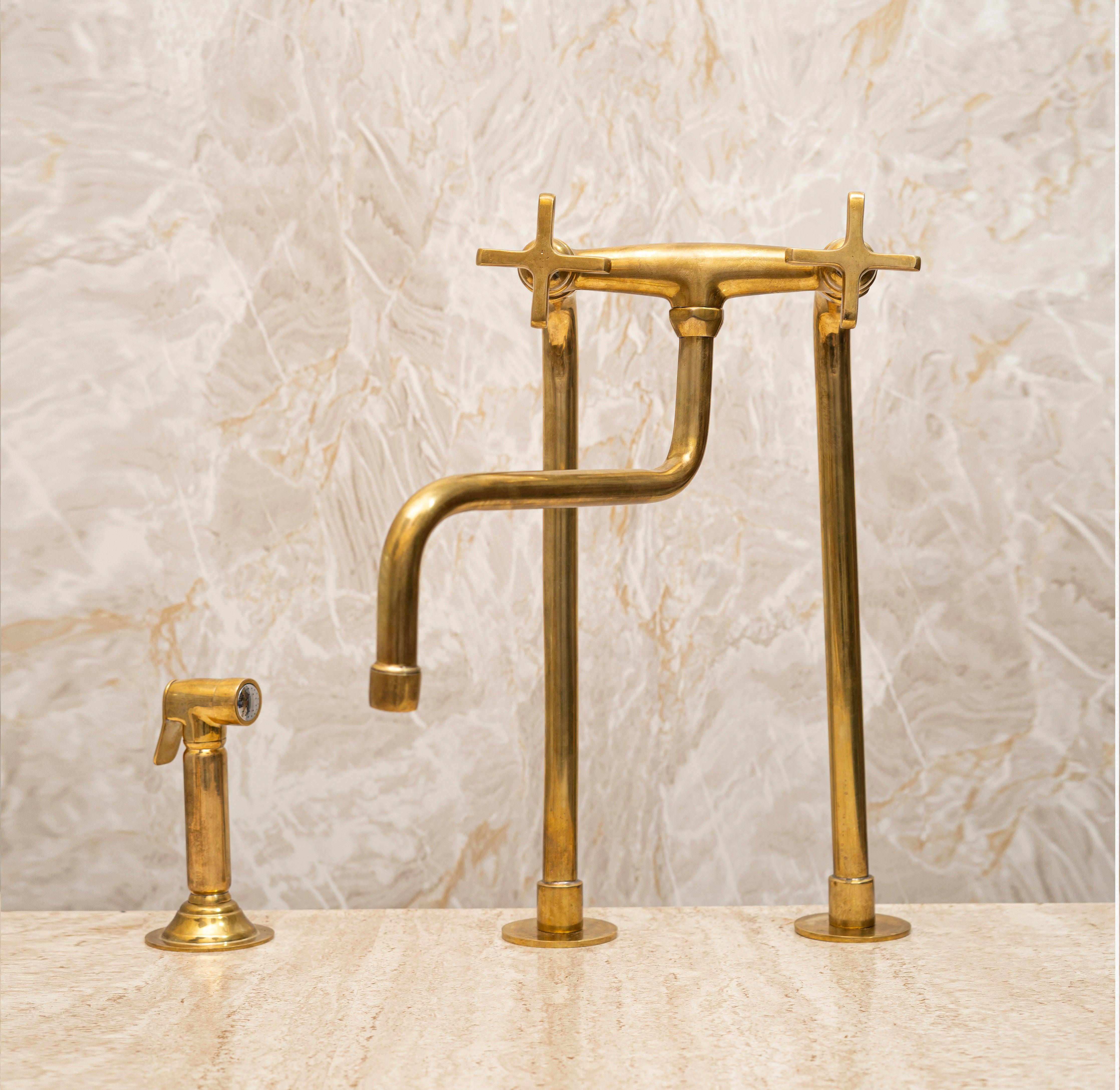 Tall unlacquered brass bridge kitchen faucet with cross handles and matching side sprayer