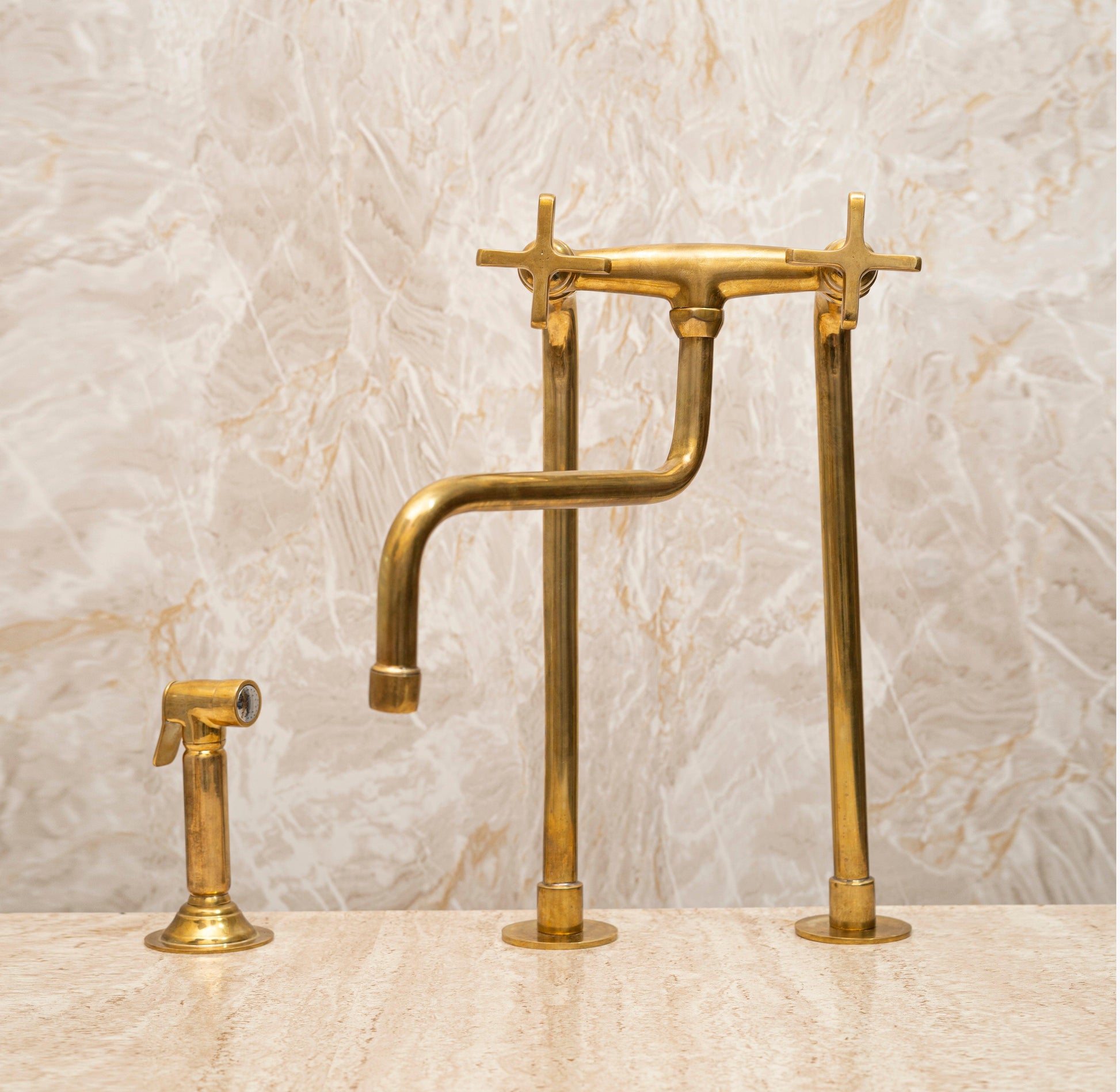 Unlacquered brass bridge kitchen faucet with flat cross handles and matching side sprayer