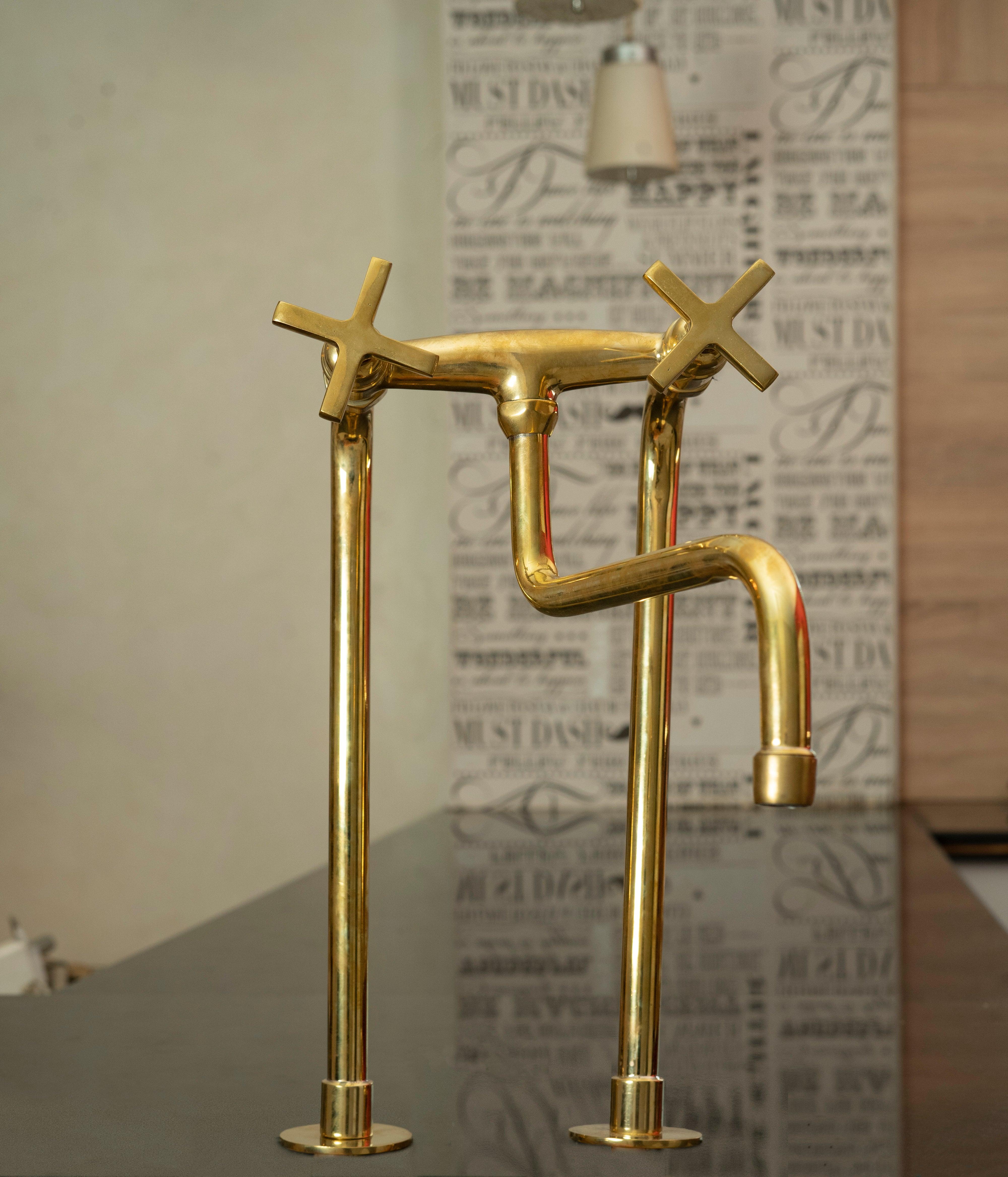 Tall unlacquered brass bridge kitchen faucet with star cross handles