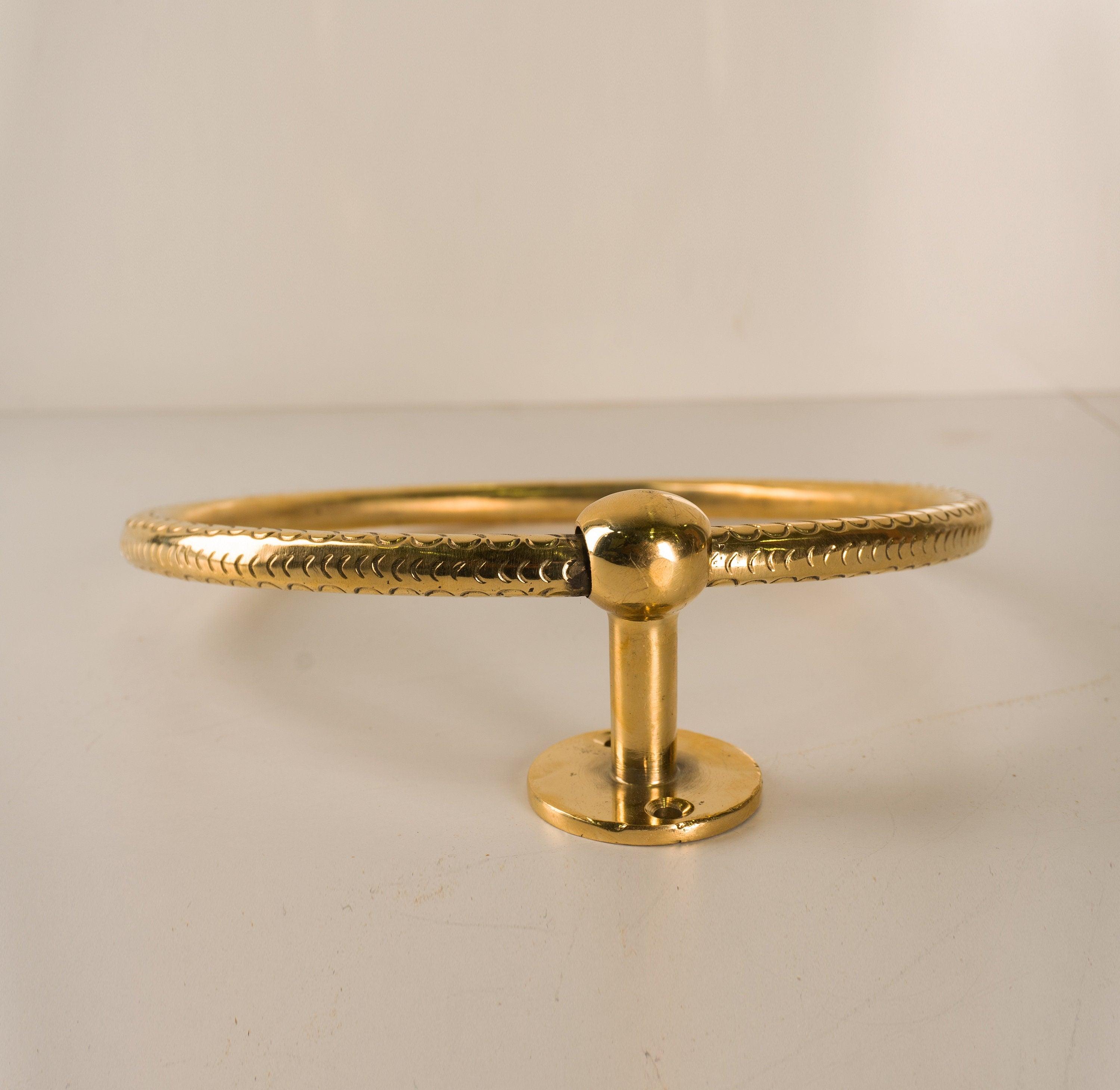 Front profile of an unlacquered brass towel ring with decorative circular rail